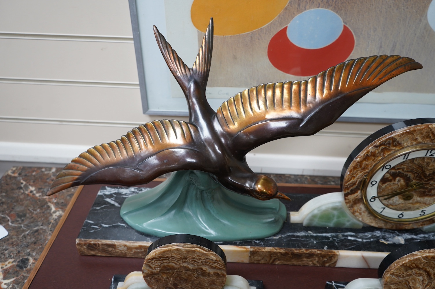 A French Art Deco marble clock garniture surmounted with a stylised spelter seagull, clock 72cm wide. Condition - fair, untested